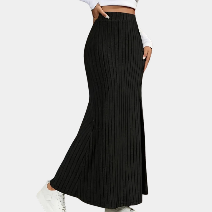 Black long fitted maxi skirt for women, designed with a modern side slit and fashionable button detailing.