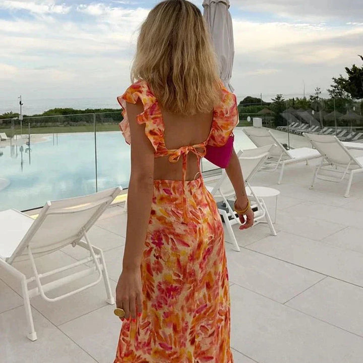 Effortlessly chic women's boho dress featuring a vibrant print, ruffles, V-neck & batwing sleeves for summer.
