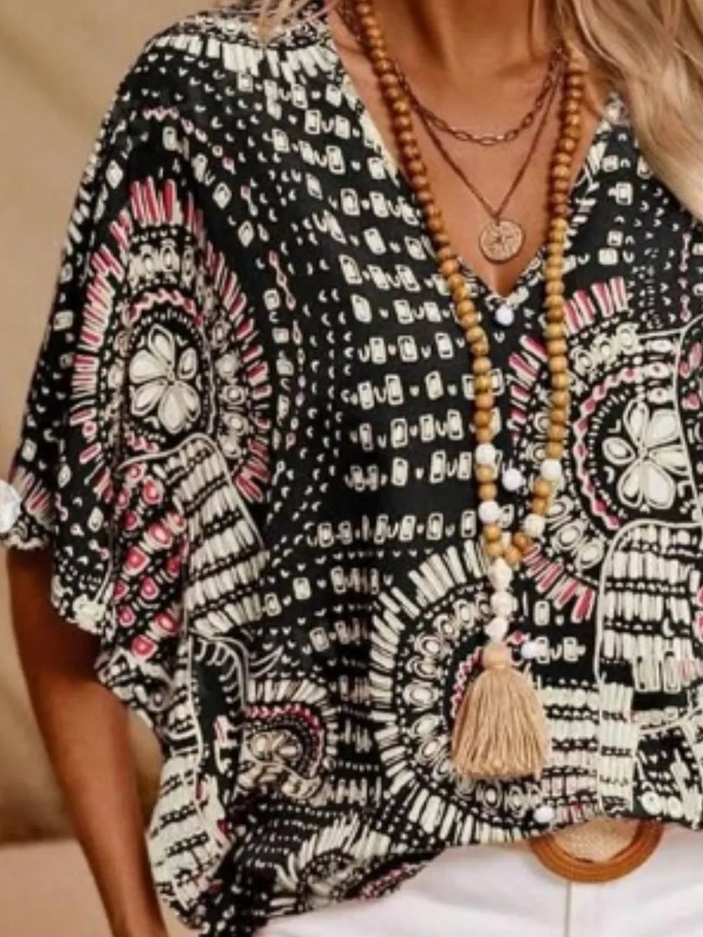 Flowy boho V-neck blouse with unique print, essential for women's summer fashion.
