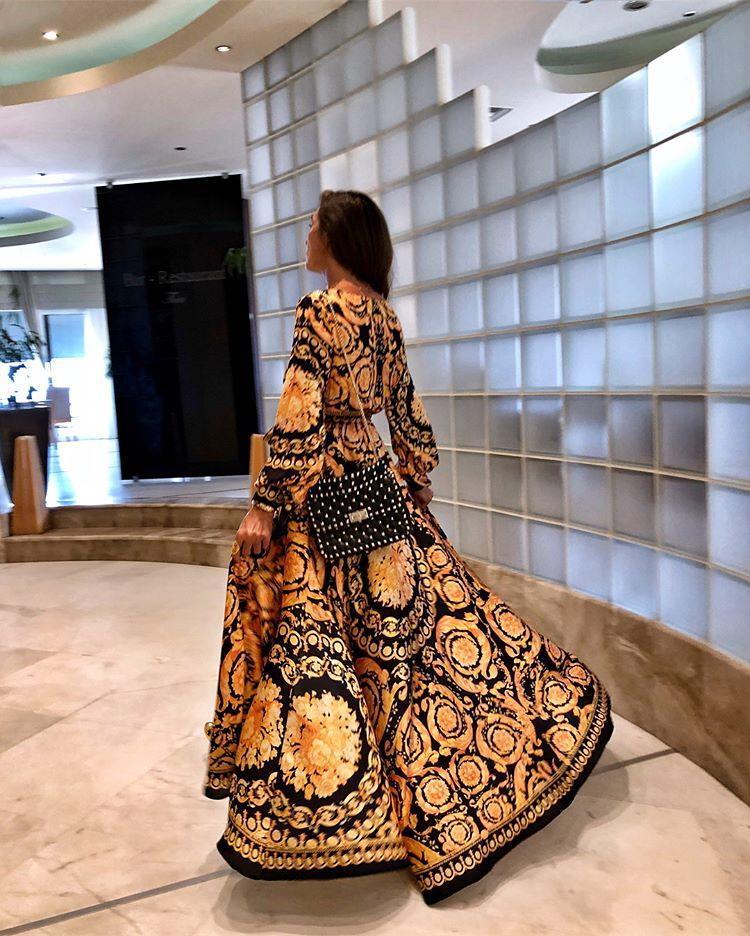 Soft women's boho maxi dress with long sleeves, wrap front, and flowy slit for summer comfort.