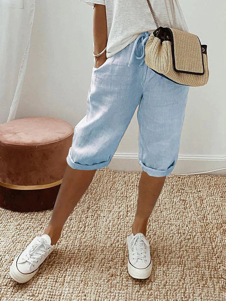 Stylish women's knee-length capri pants with pockets. Breathable fabric & flexible fit for summer comfort.