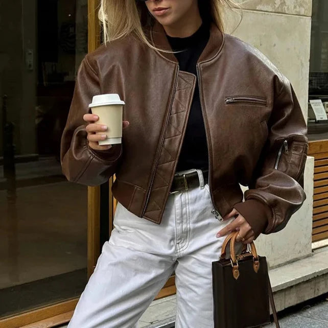 Stylish women's cropped bomber jacket in vintage brown, a versatile statement piece for street style.