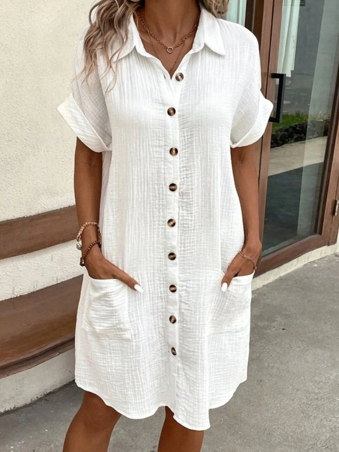 Women's casual button-down mini dress with practical pockets, perfect for summer everyday wear.