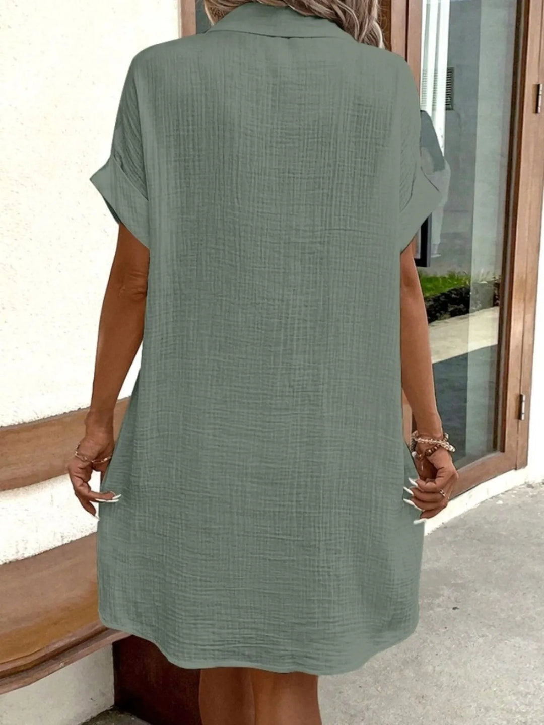 Women's relaxed fit mini dress, button-down front and practical pockets, great for casual wear.