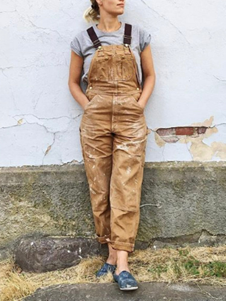 Close-up of a women's utility jumpsuit showing spacious front pockets and durable fabric for practical wear.