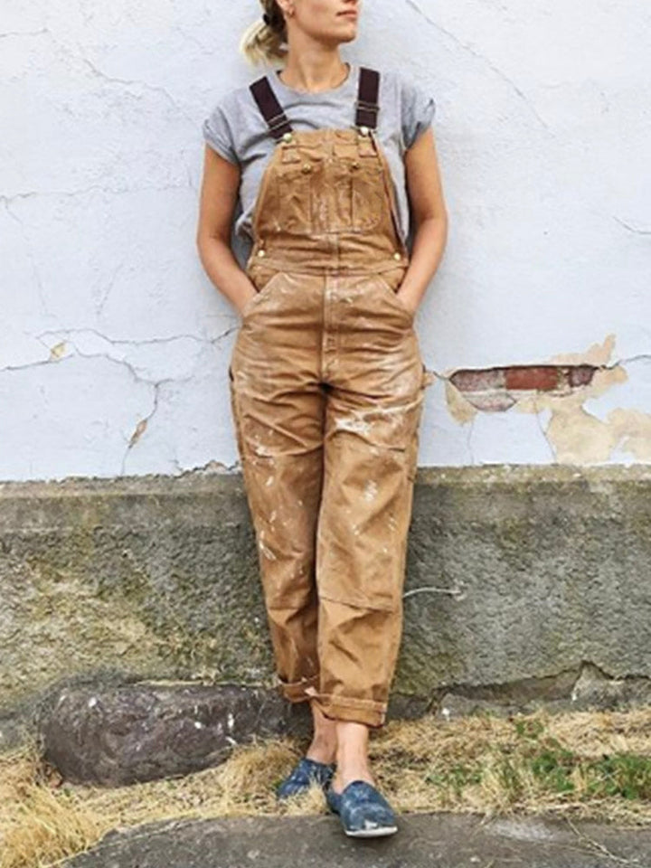 Close-up of a women's utility jumpsuit showing spacious front pockets and durable fabric for practical wear.
