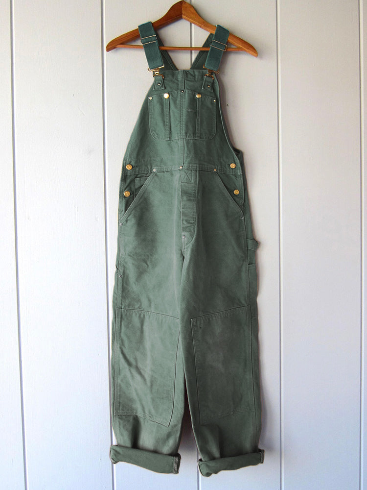 Stylish women's workwear-inspired dungaree jumpsuit, designed for comfort and durability in an all-season fabric.