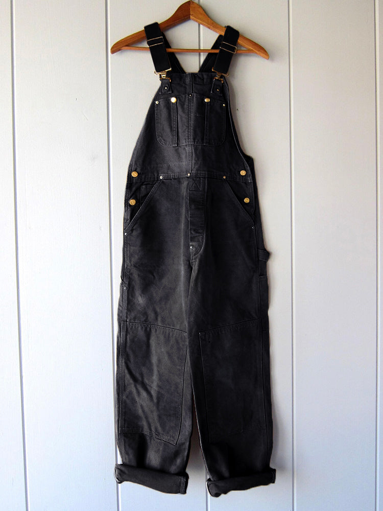 Full-length shot of a women's sleeveless utility jumpsuit, a modern take on the classic dungaree, for casual fashion.