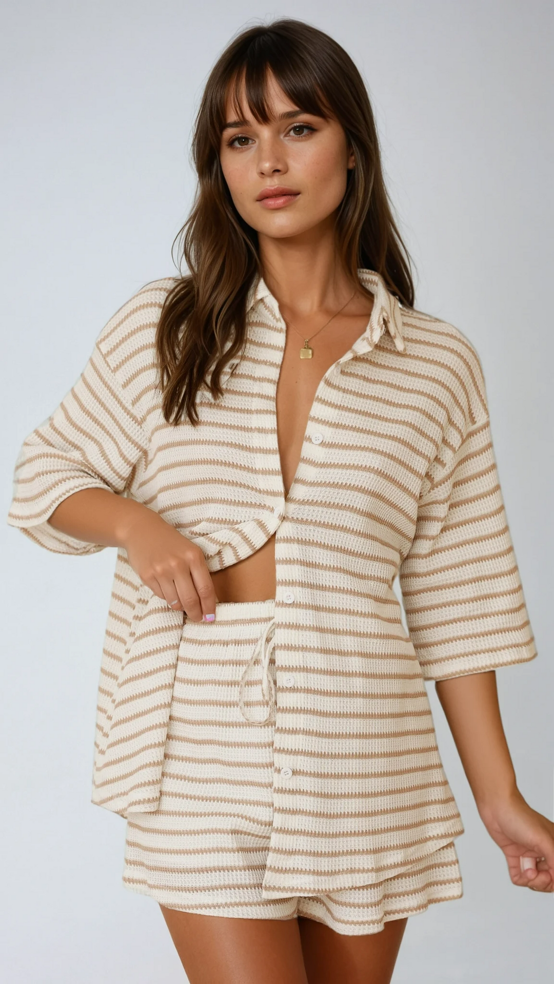 Women's chic beige striped button-up shirt and matching high-waisted shorts set, perfect for summer fashion.