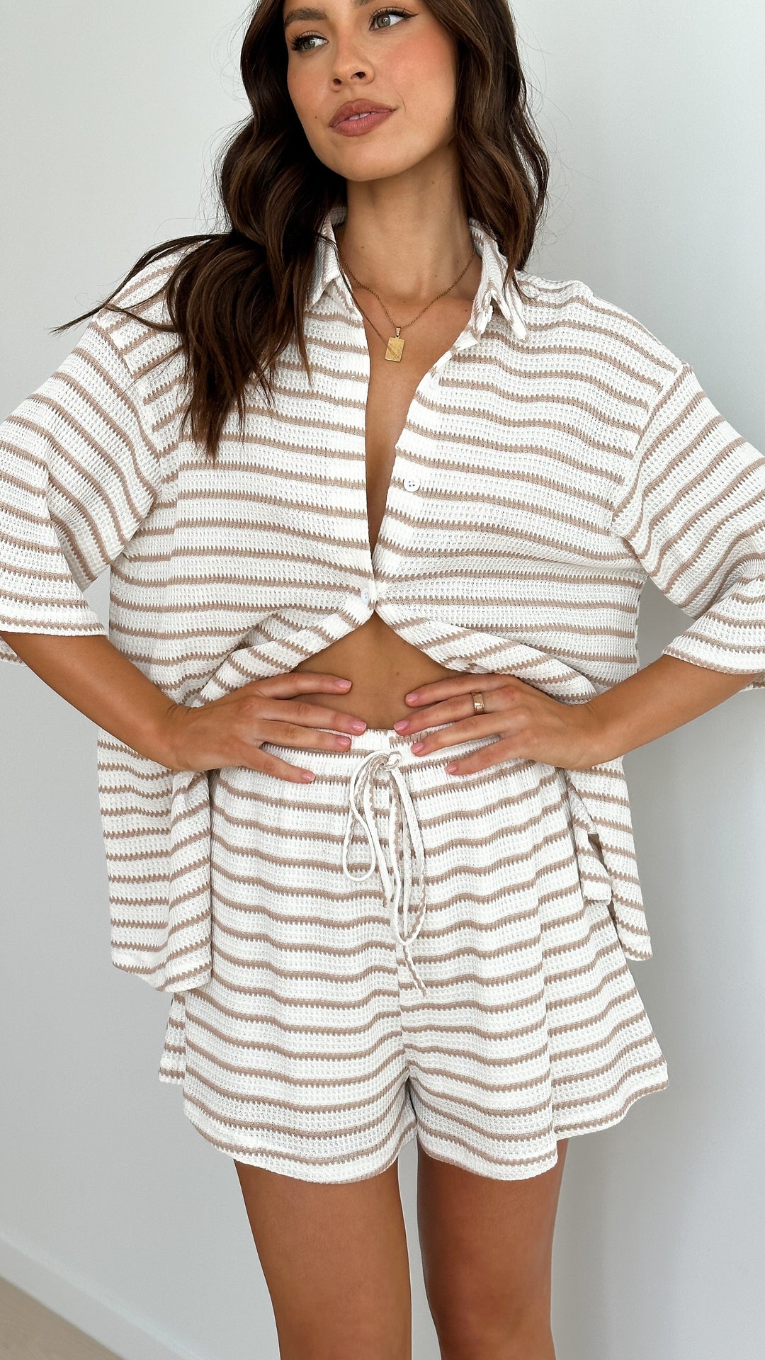 Elegant women's beige striped shirt & shorts co-ord set, ideal for chic casual wear or a stylish vacation outfit.