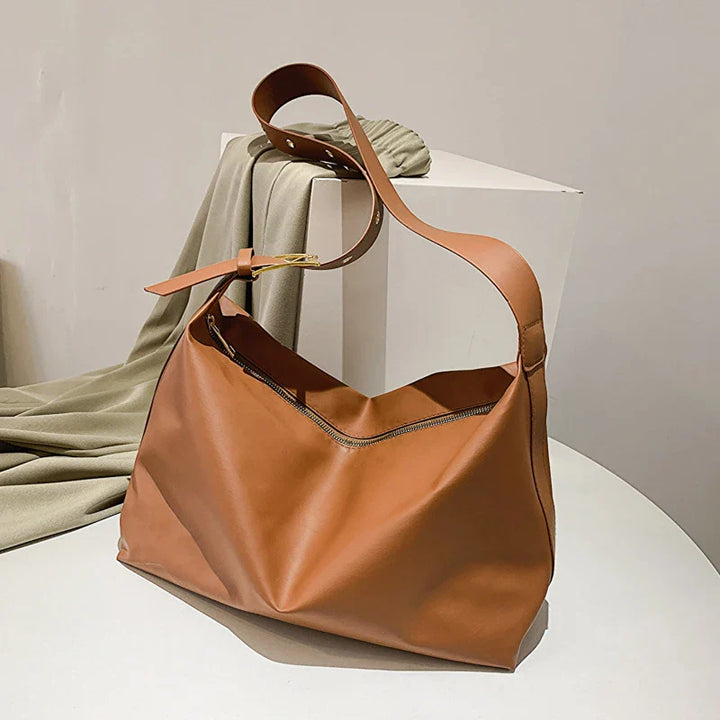 Elegant empty black faux leather slouchy shoulder tote bag, showcasing its chic versatile design.