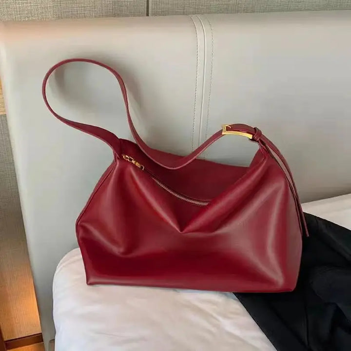 Stylish faux leather slouchy shoulder tote bag laid flat, highlighting its chic design and versatility.