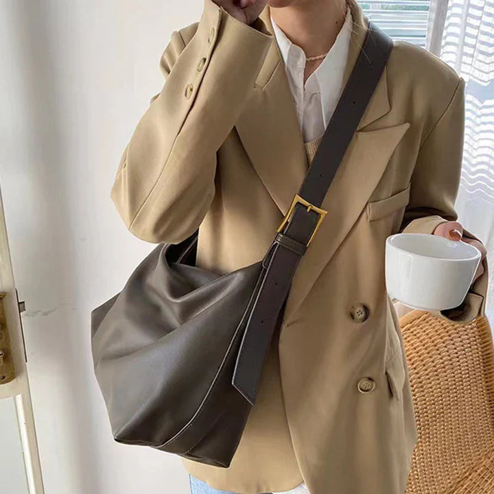 Back view of a chic women's black faux leather slouchy shoulder bag, comfortable and fashionable.