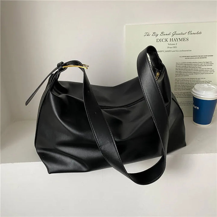 Side view of spacious women's faux leather hobo tote bag, perfect for daily essentials & style.