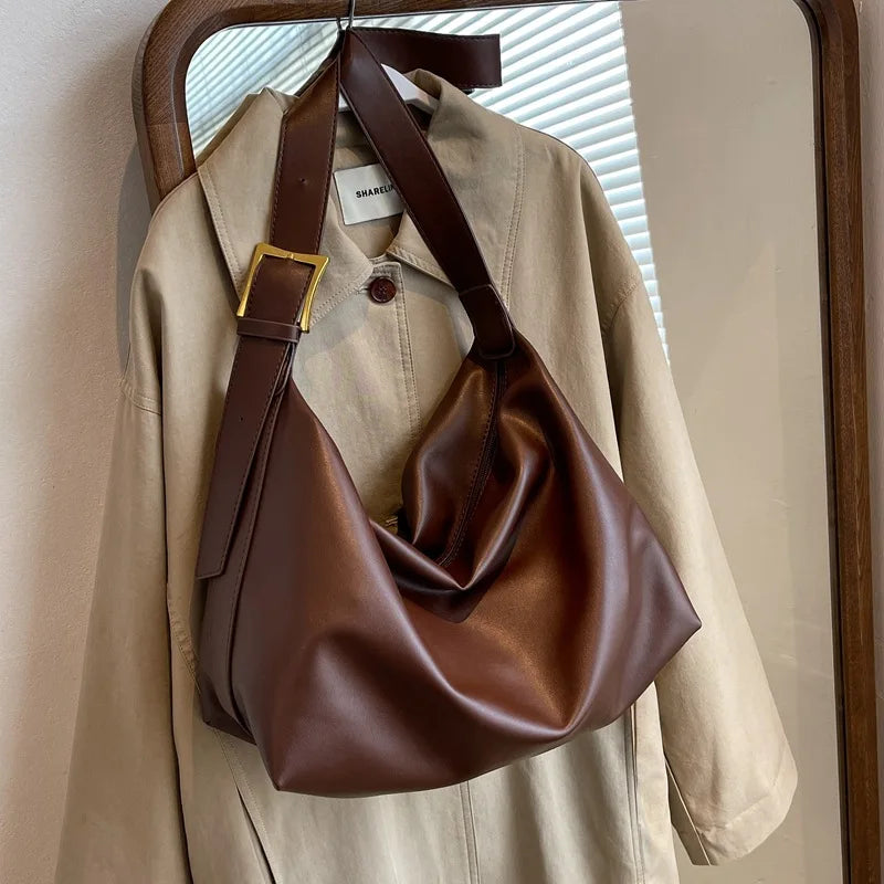 Comfortable wide shoulder strap of a women's faux leather slouchy bag, designed for versatility.