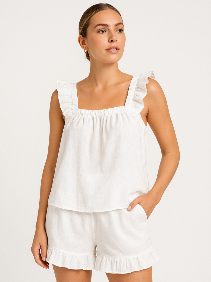 Women's chic ruffle pajama set. Cozy two-piece summer sleepwear with sleeveless top & shorts. Ideal for warm weather.