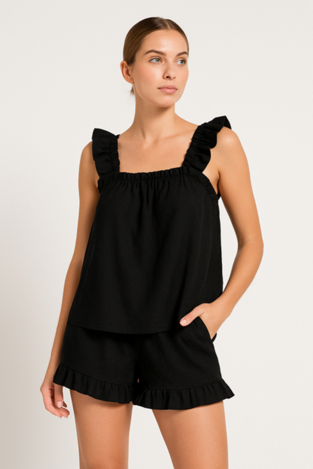 Feminine ruffle summer pajama set. Loose fit, comfortable women's two-piece loungewear with sleeveless top & shorts.