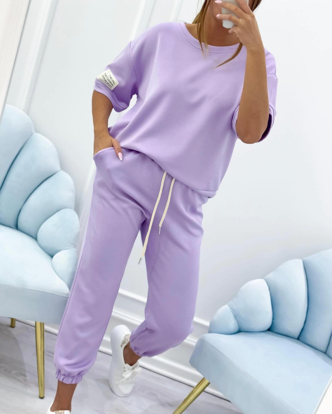 Casual women's short sleeve top and long pants set. Ideal for summer relaxation and everyday wear.