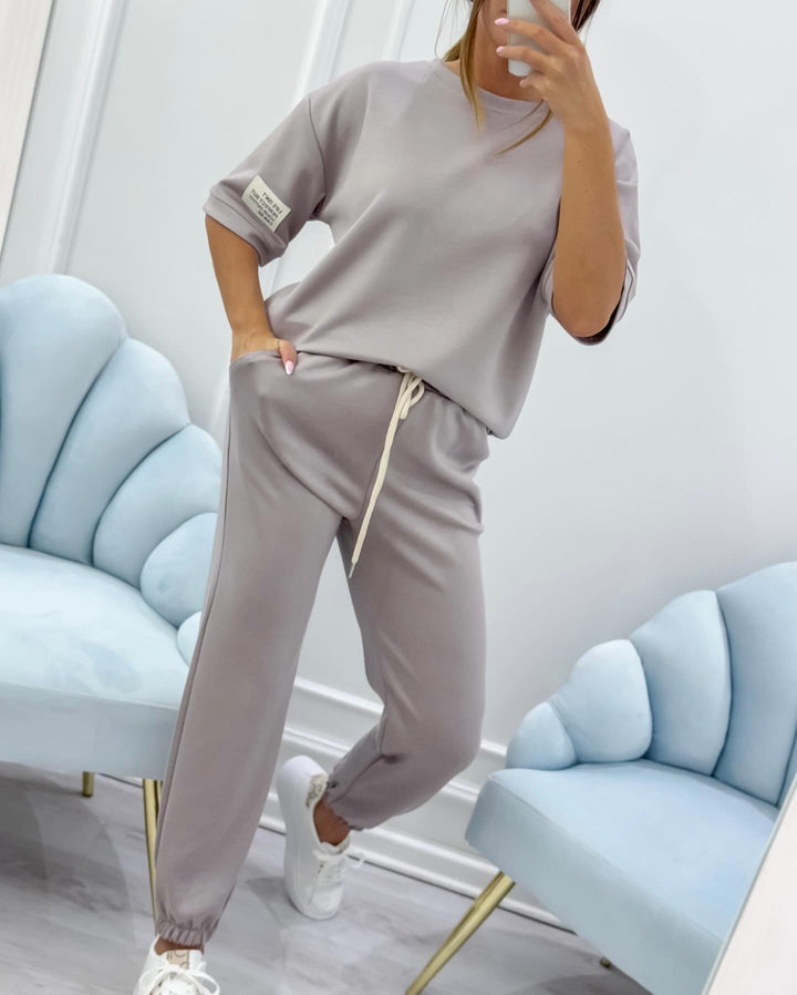 Summer fashion women's short sleeve shirt and elastic waist pants set. Versatile two-piece outfit.