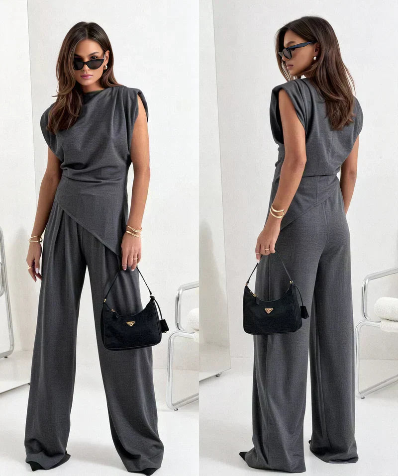 Woman wearing chic loungewear top, part of an elegant two-piece set. Comfortable women's fashion.