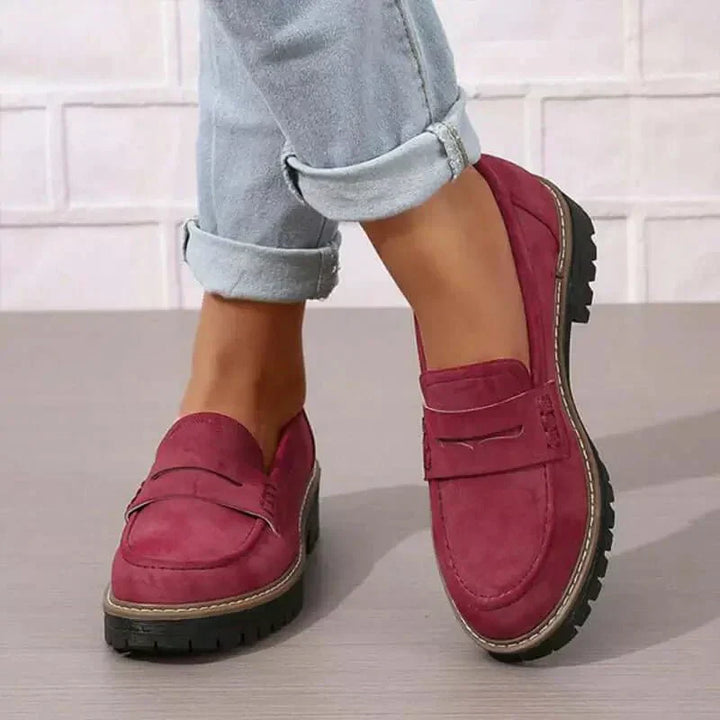 Women's everyday footwear: black chunky platform loafers with a comfortable slip-on design and round toe.