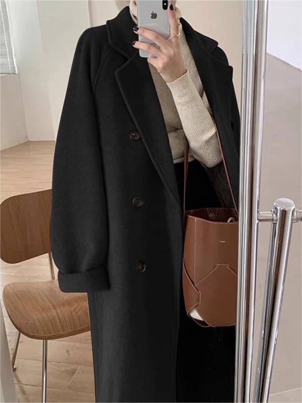 Close-up of a women's classic belted winter coat, highlighting the elegant lapel collar & warm fabric texture.
