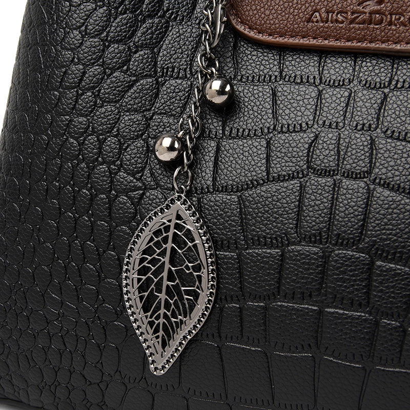 Versatile women's everyday bag. Faux leather handbag that doubles as a stylish tote or shoulder bag.