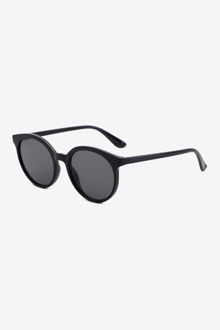 Close-up of women's classic round UV400 sunglasses, highlighting frame and tinted lens detail.