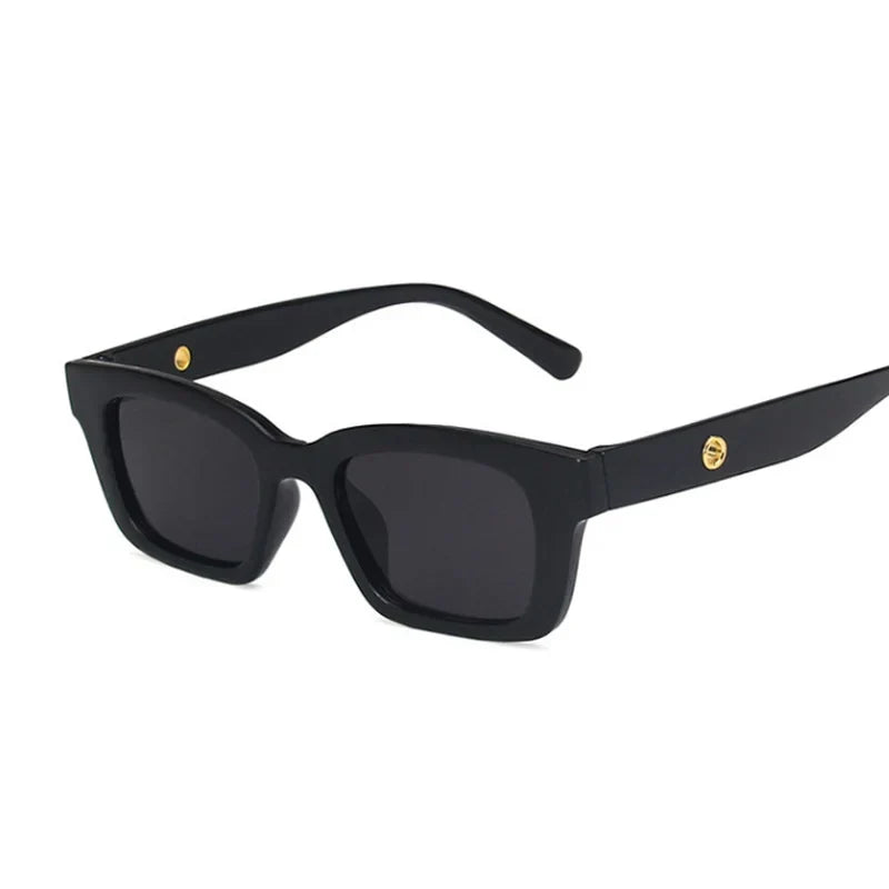 Chic women's wayfarer rectangular sunglasses, dark lenses with luxurious gold accent. UV protection eyewear.