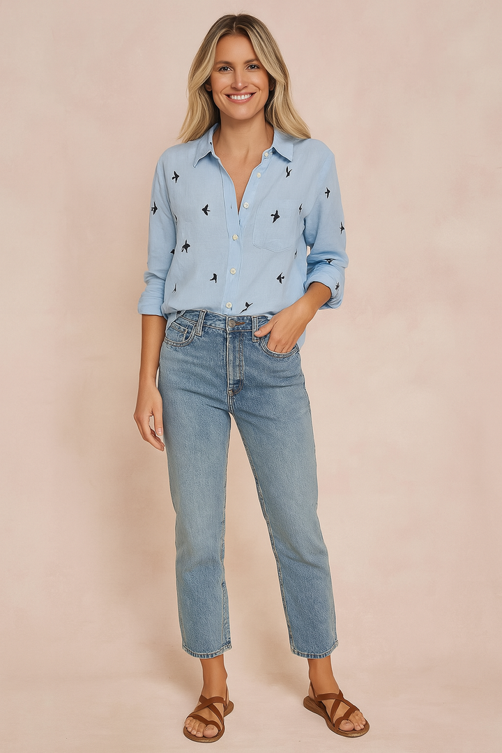 Women's classic white button-up blouse, perfect for casual everyday wear or office style. Relaxed long-sleeve top.