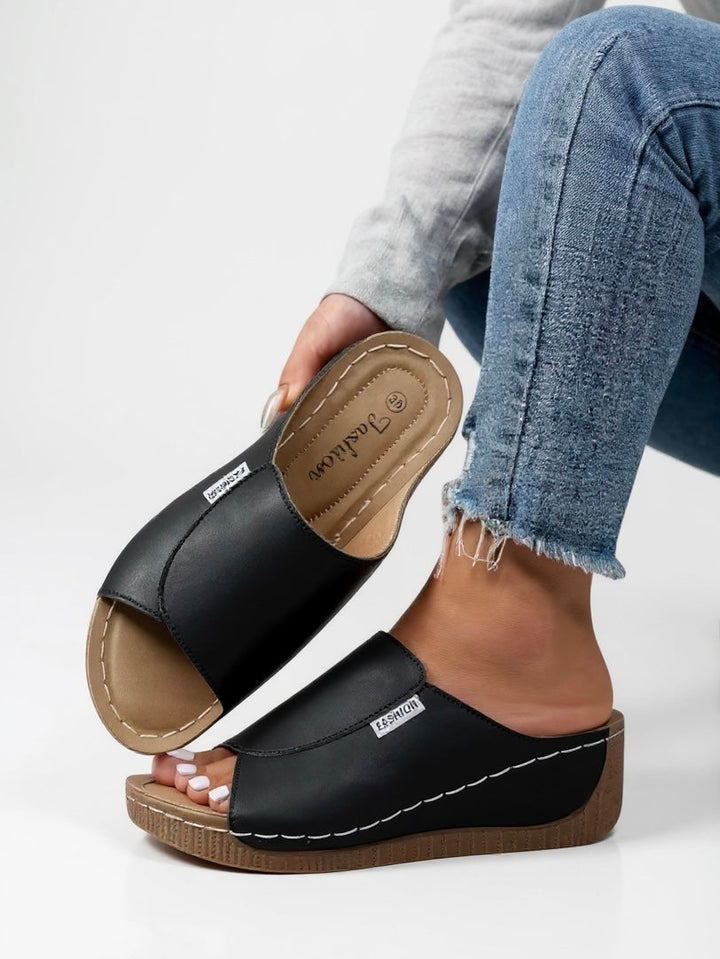 Chic women's platform sandals with a modern design. Elevated slip-on style for comfort footwear.