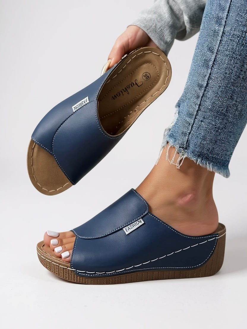 Comfortable women's platform slides. Modern, slip-on footwear for elevated everyday wear and chic style.