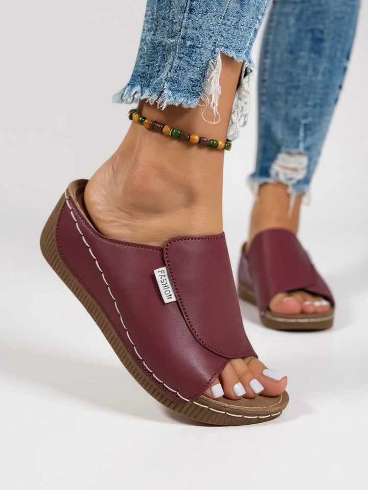 Modern women's platform sandals, offering everyday comfort. Minimalist slip-on style for elevated fashion.