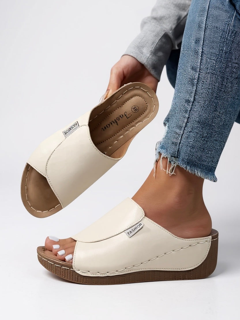 Elevated women's comfort platform slides. Modern, minimalist design for stylish everyday summer wear.