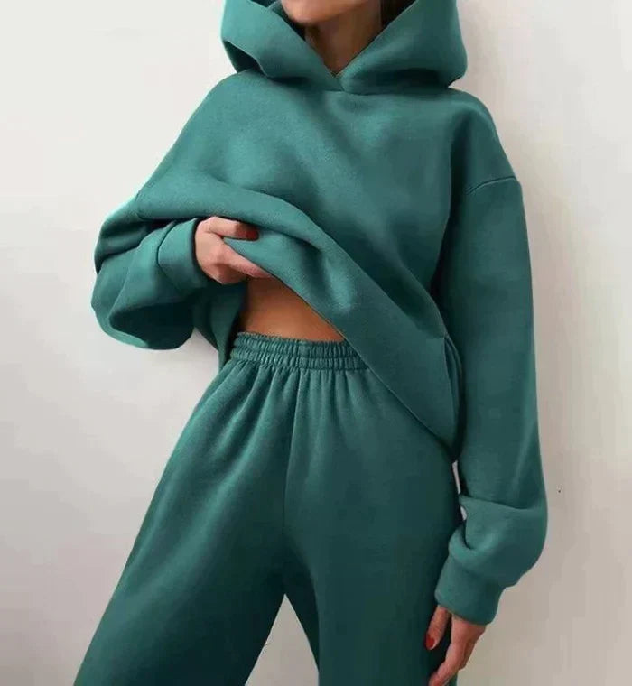 Relaxed fit women's two-piece loungewear set, featuring a stylish hoodie & comfortable jogging pants.