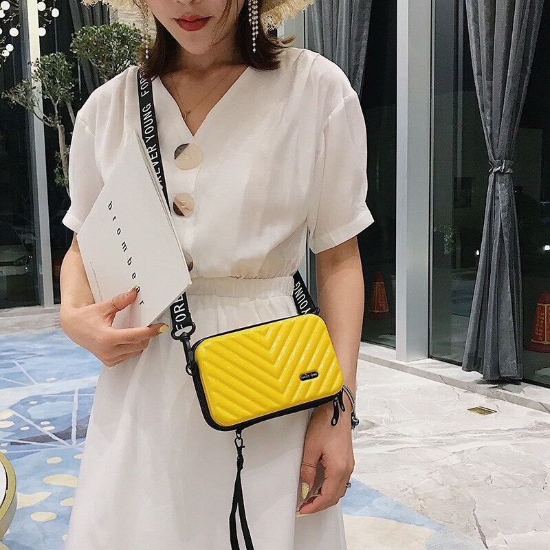 Modern stylish compact hard shell crossbody bag for women, perfect accessory for urban travel.