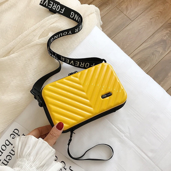 Durable vegan leather hard shell crossbody bag for women, compact & stylish travel handbag.