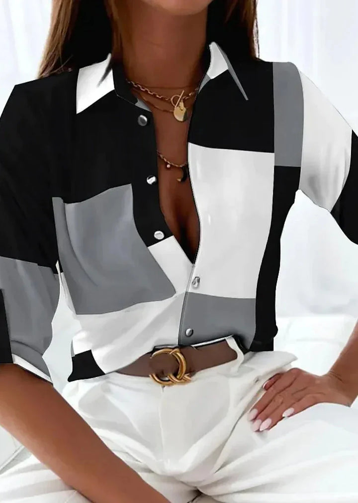 Stylish women's black and white printed blouse. Versatile longsleeve top for officewear or casual elegance.