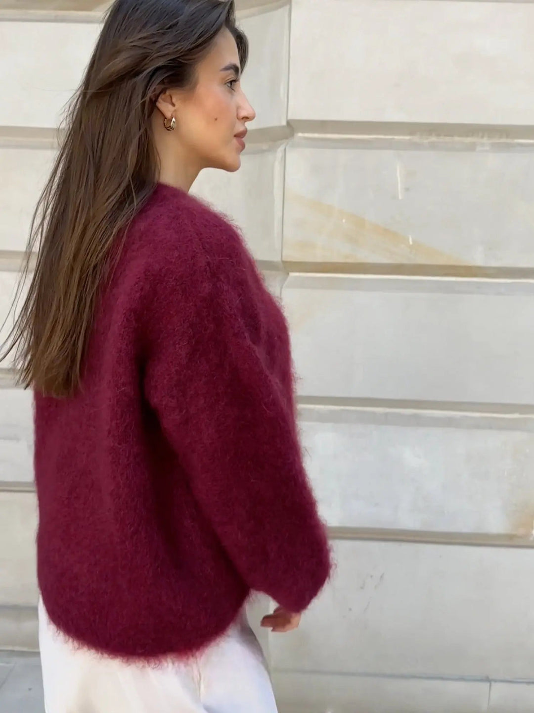 Soft, elegant women's textured knit sweater in a relaxed fit, a versatile layering piece for fall/winter.