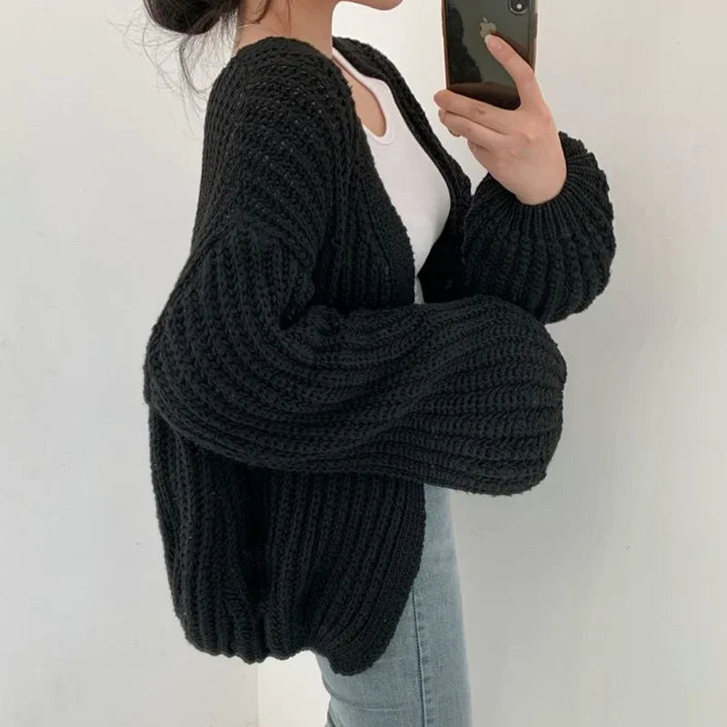 Stylish women's fall fashion layering piece: an oversized knit cardigan with a comfortable, relaxed fit.