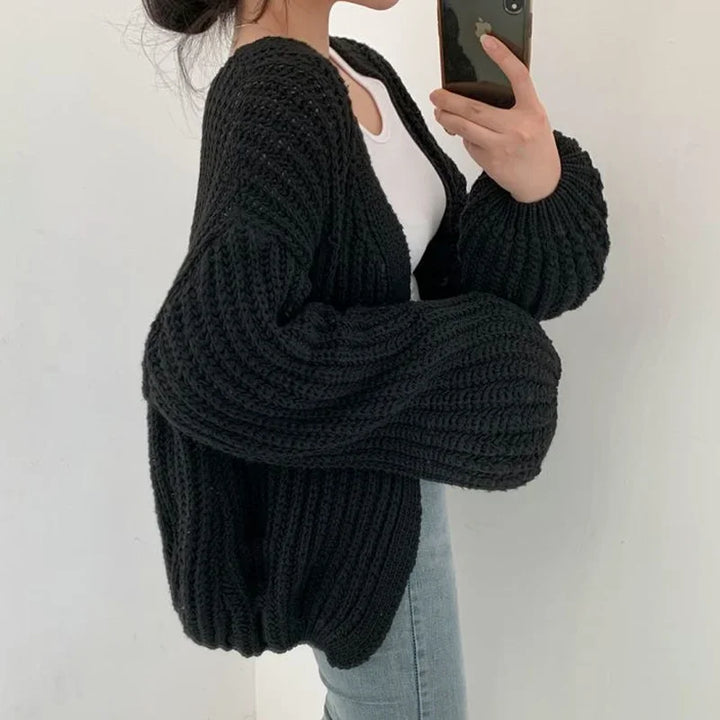 Stylish women's fall fashion layering piece: an oversized knit cardigan with a comfortable, relaxed fit.