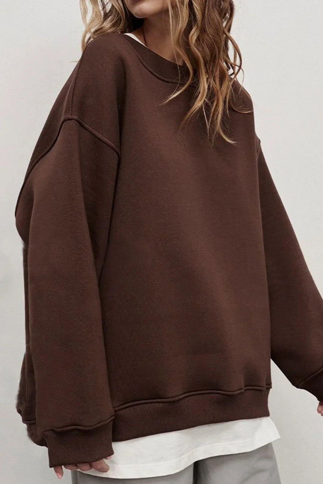 Relaxed fit women's oversized round neck sweatshirt. Cozy, comfortable top for everyday casual and street style.