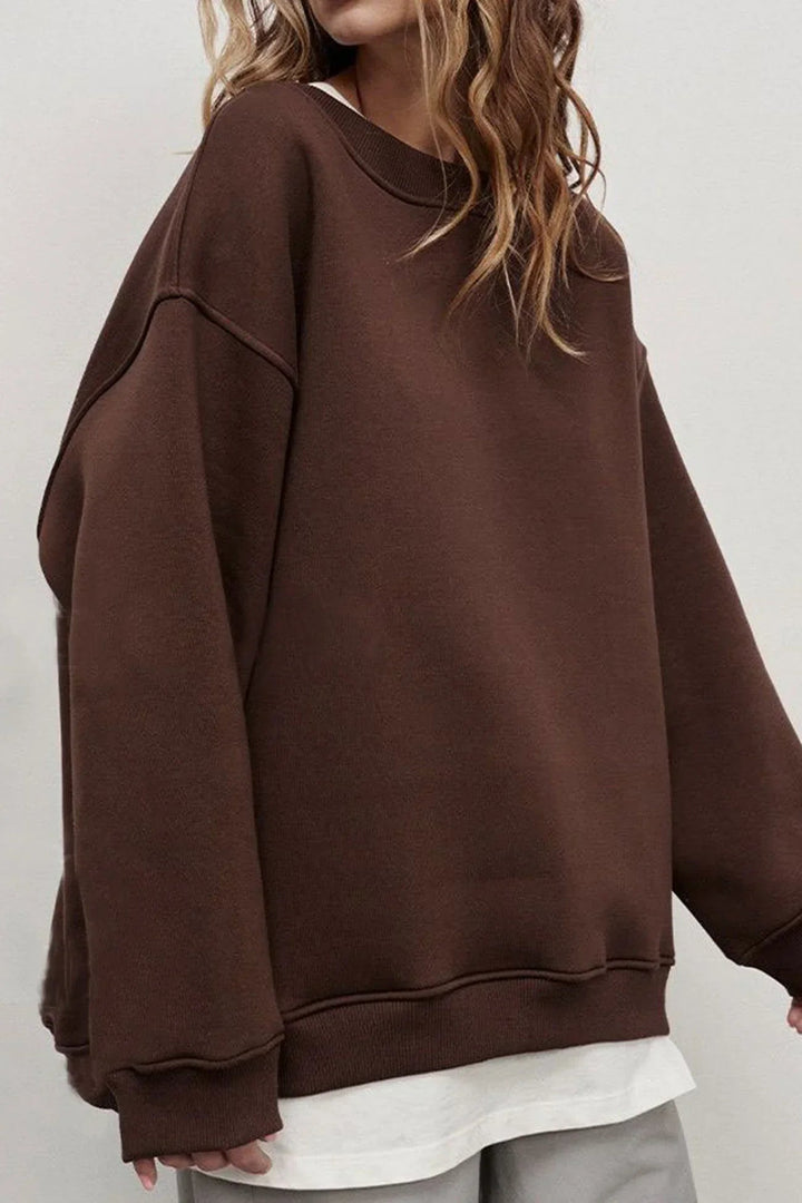 Relaxed fit women's oversized round neck sweatshirt. Cozy, comfortable top for everyday casual and street style.