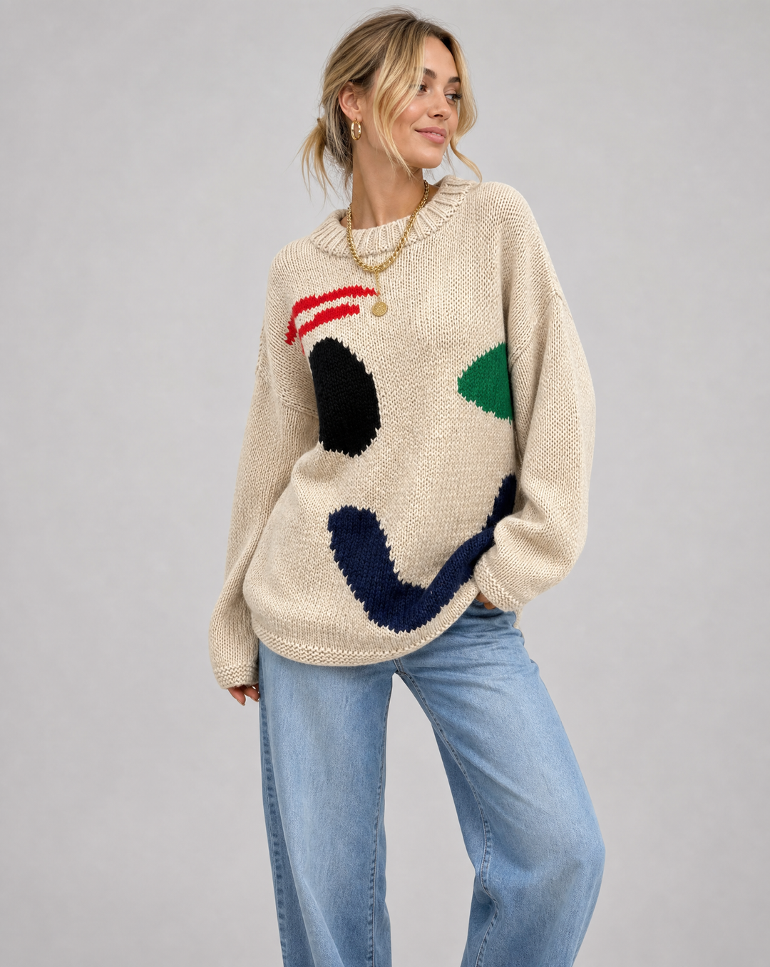 Women's cozy oversized smiley face sweater in soft knit. Perfect for casual fall and winter warmth, a trendy loose fit top.