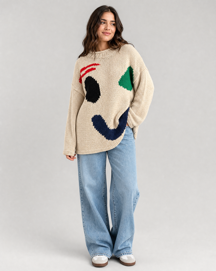 Back view of a women's cozy oversized knit sweater, showcasing its loose fit and comfortable design for winter warmth.