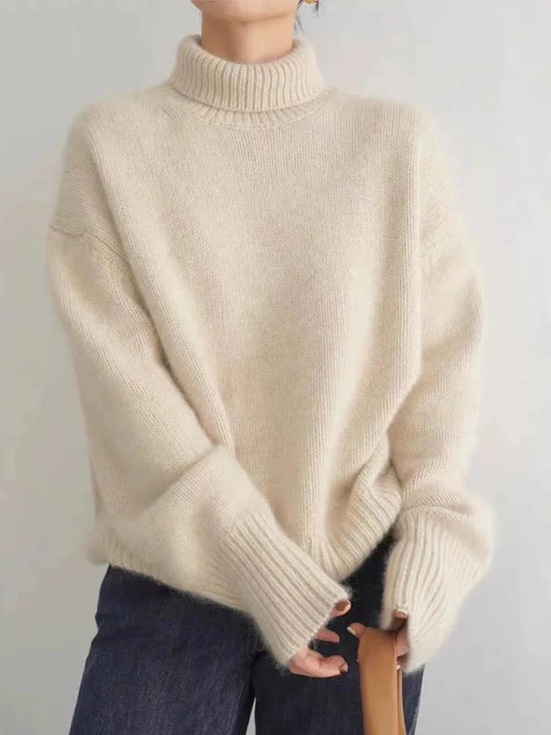 Stylish women's relaxed fit turtleneck sweater, an essential for winter fashion layering.