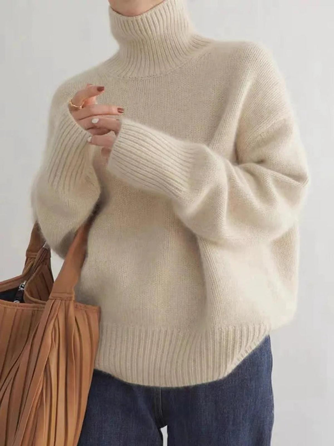 Warm women's long sleeve turtleneck sweater, ideal for chilly winter days.