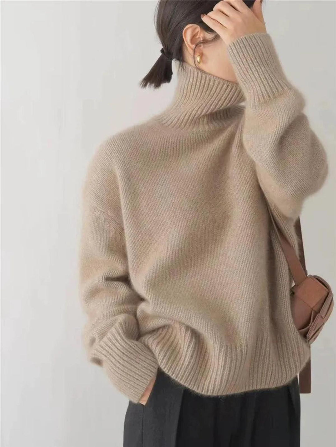 Women's stylish & warm turtleneck sweater, a cozy essential for cold weather fashion.