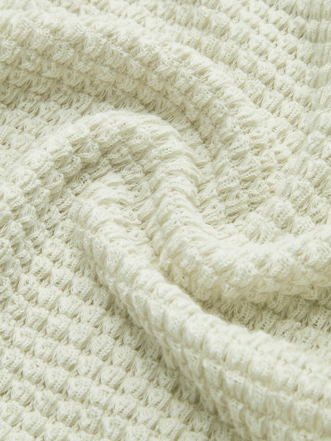 Women's casual long sleeve top featuring a cozy waffle knit texture, perfect for relaxing.