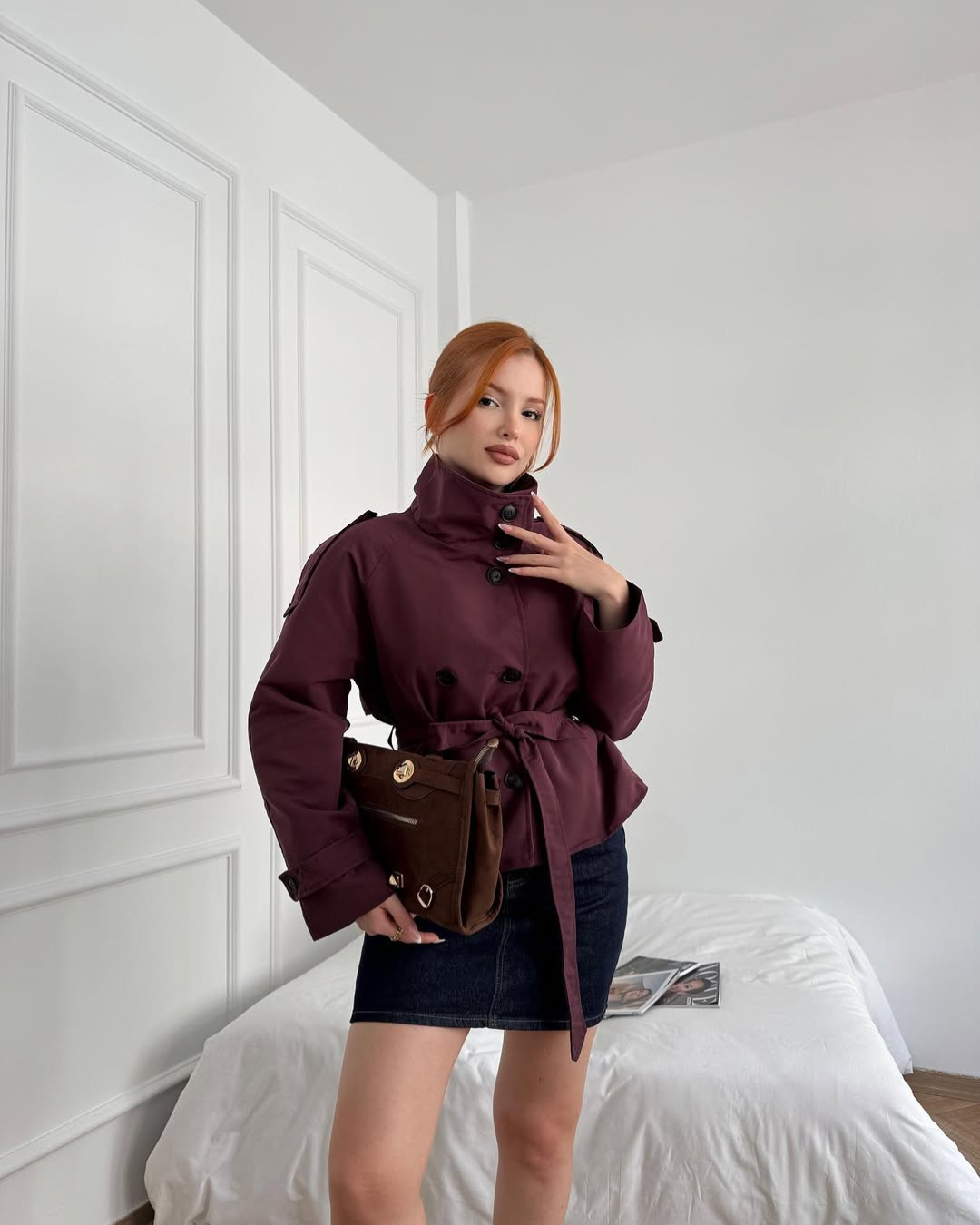 Modern women's cropped belted trench coat, double-breasted, ideal for versatile fall outerwear.